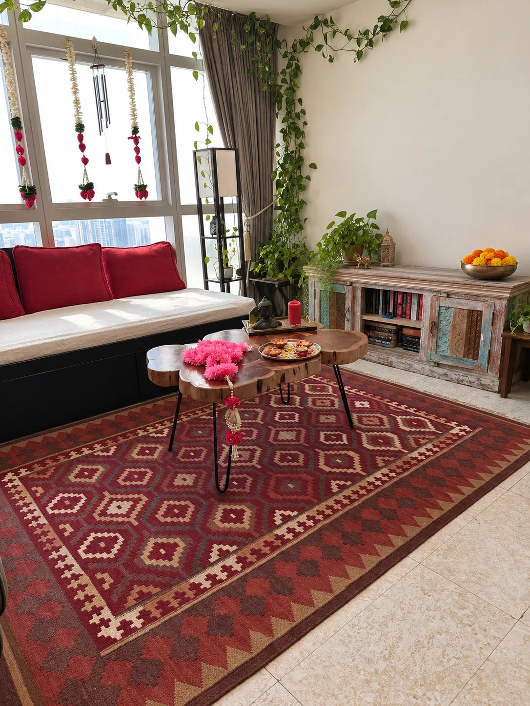 Kilim area rug with a geometric tribal pattern in red, brown, and beige, styled in a cozy living room for holiday decor