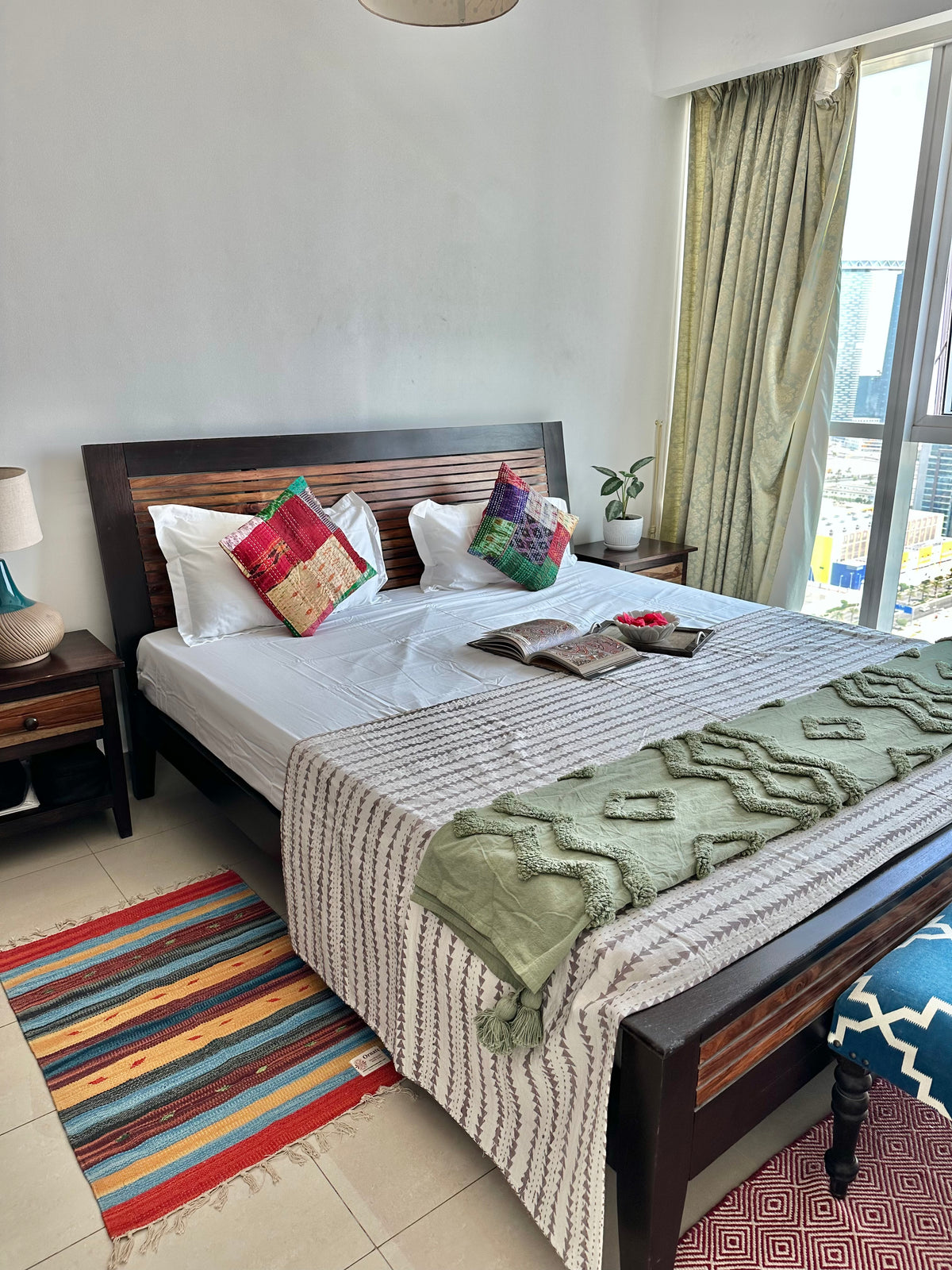 Grey arrow Kantha quilt draped over end of bed for a boho decor