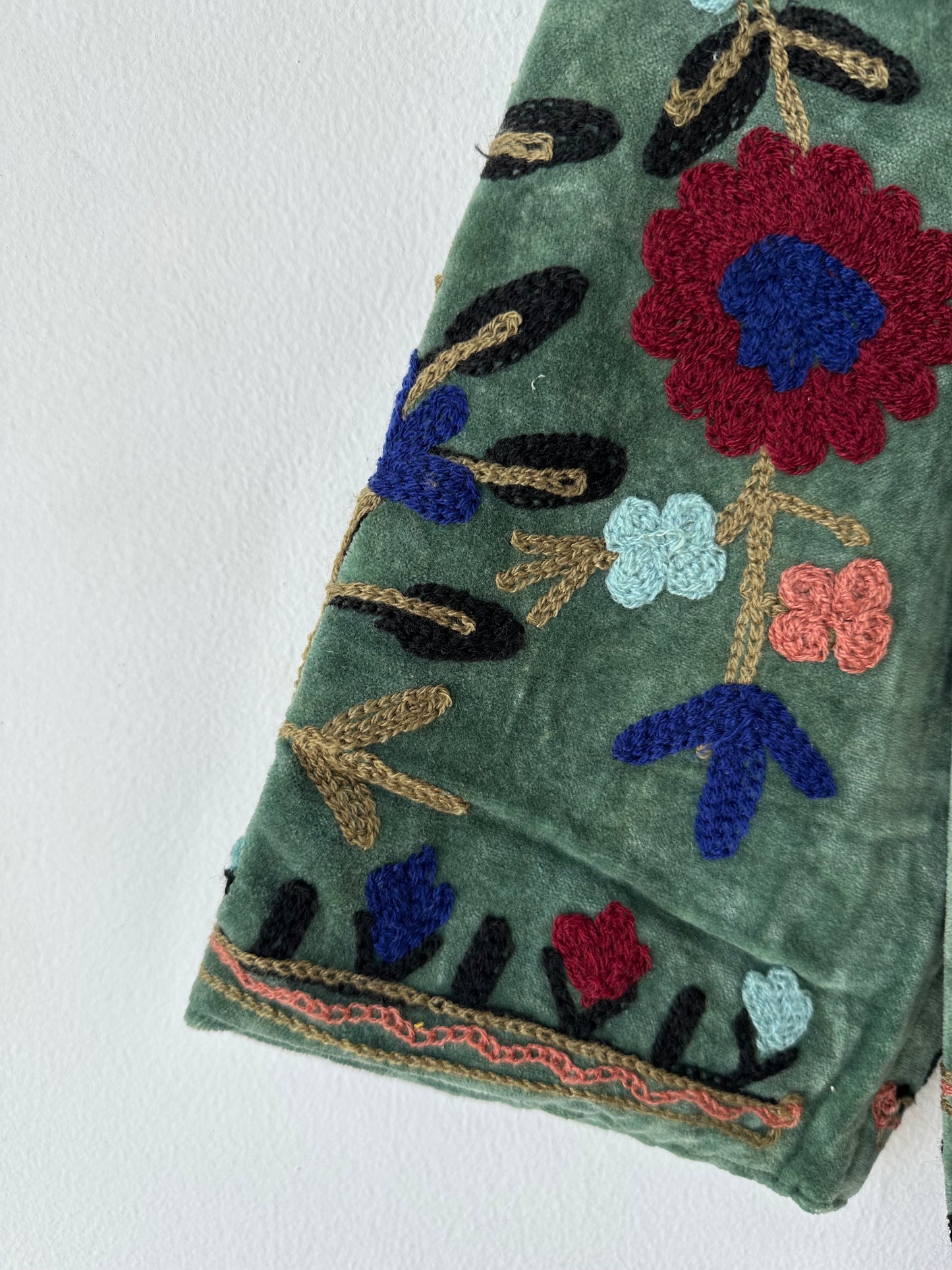 Green Embroidered velvet jacket with colorful patterns & cotton inner lining. perfect for holiday parties or date nights. Artisan made ideal for holiday gifting. Made by artisans in India for Ornate Handicrafts