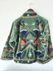 Green Embroidered velvet jacket with colorful patterns & cotton inner lining. perfect for holiday parties or date nights. Artisan made ideal for holiday gifting. Made by artisans in India for Ornate Handicrafts