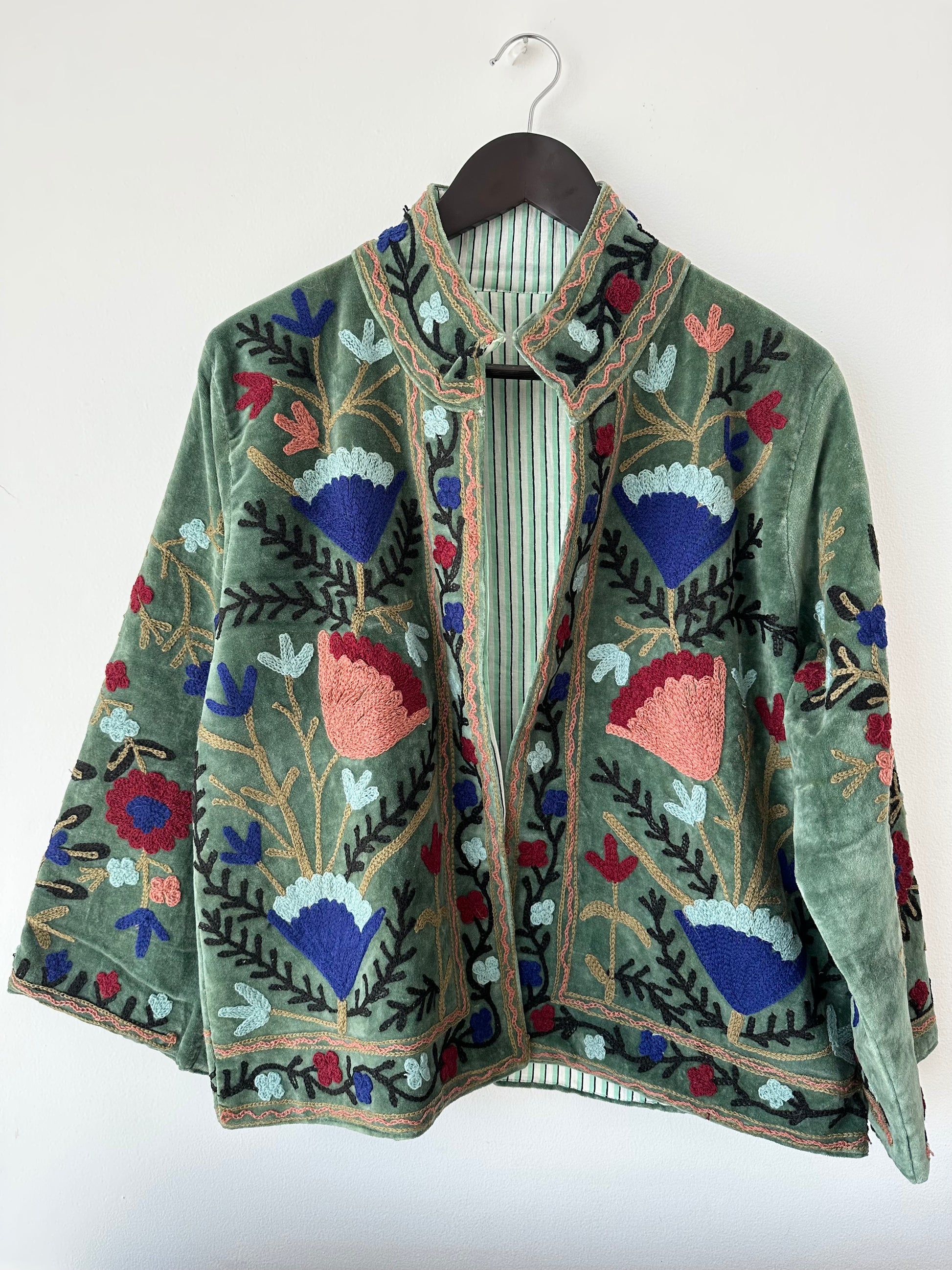 Green Embroidered velvet jacket with colorful patterns & cotton inner lining. perfect for holiday parties or date nights. Artisan made ideal for holiday gifting. Made by artisans in India for Ornate Handicrafts