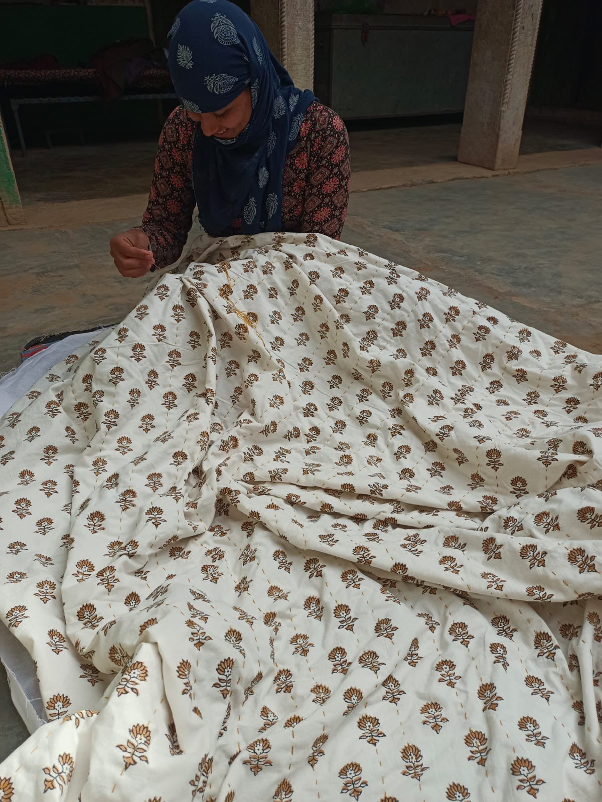 Women artisans working on kantha quilt for Ornate Handicrafts